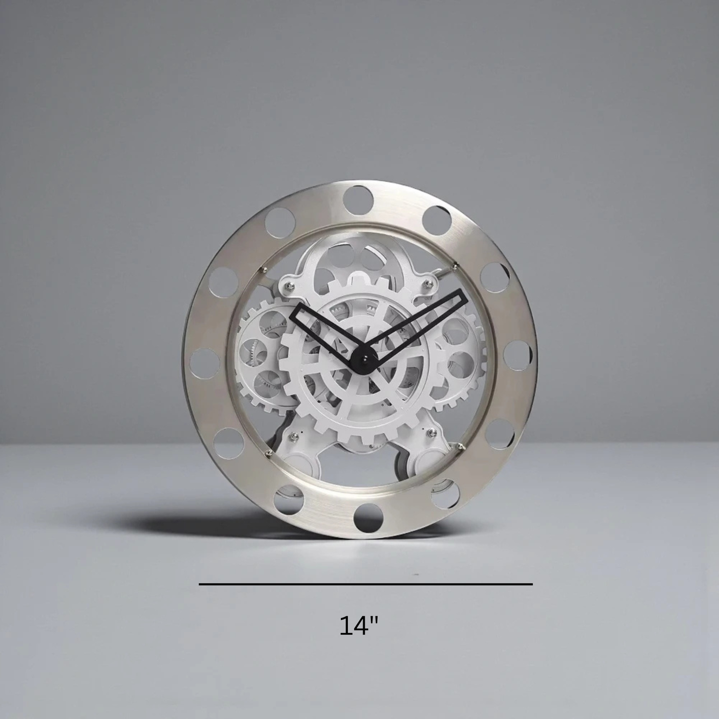 Modern Wall Clock Design - Elverton features exposed interlocking gears behind bold Roman markers, framed by riveted gun-metal trim, with black hands on a transparent gear assembly, embodying a stunning mechanical aesthetic.