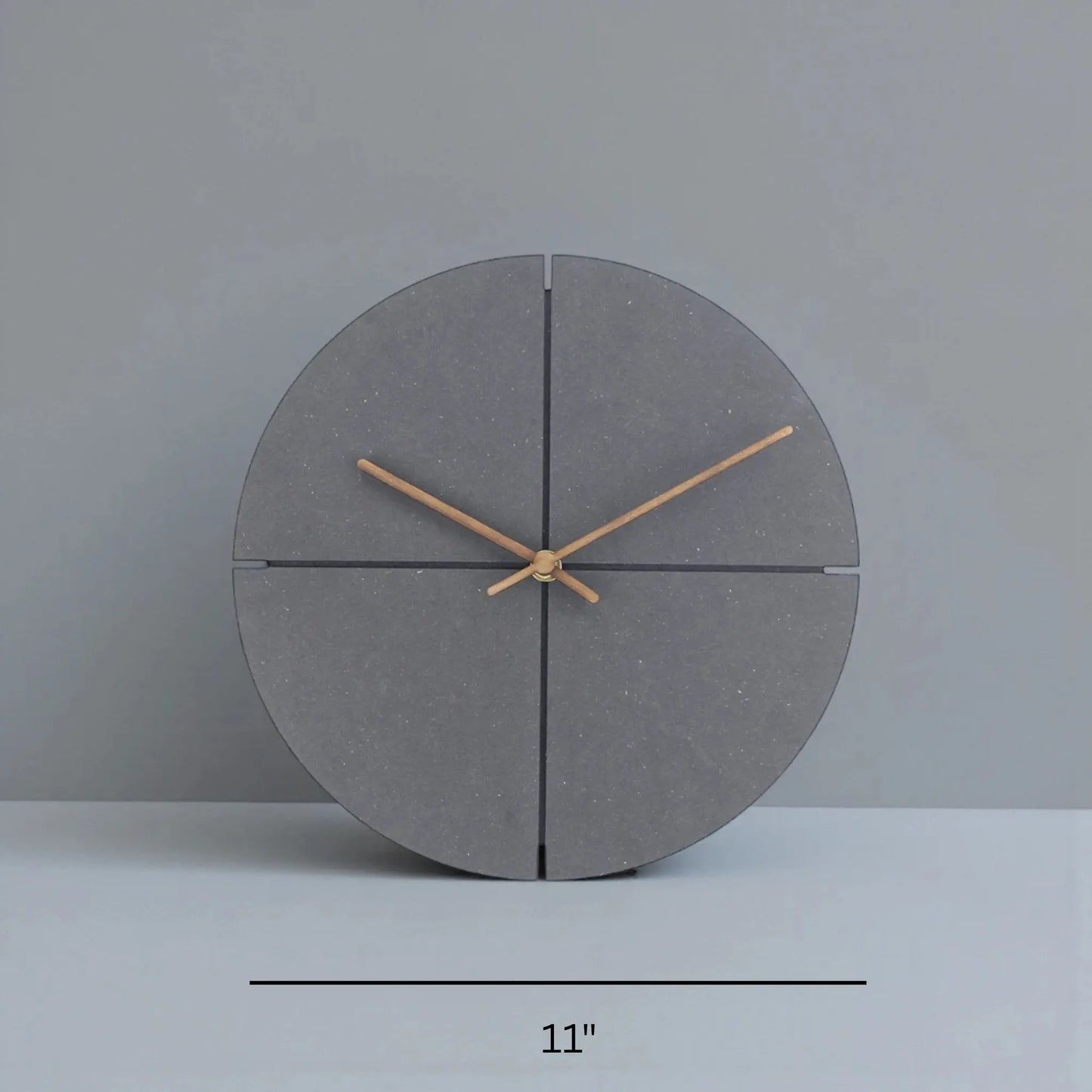 Deep Black Wall Clock Modern - Grenton: An 11-inch dark gray circular tabletop clock with wooden hands and quadrant grooves, offering a sleek, minimalist design that blends modern sophistication with a warm wood contrast.