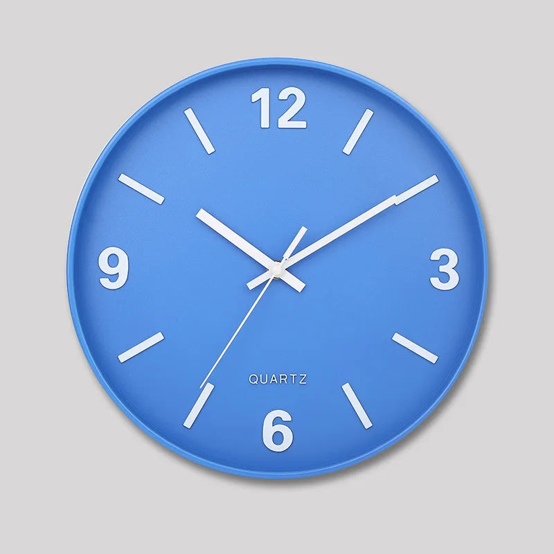 Modern Silent Wall Clock - Densford features a blue face with white markers and hands, emphasizing a minimalist design. Perfectly silent, this elegant clock enhances any room's decor.