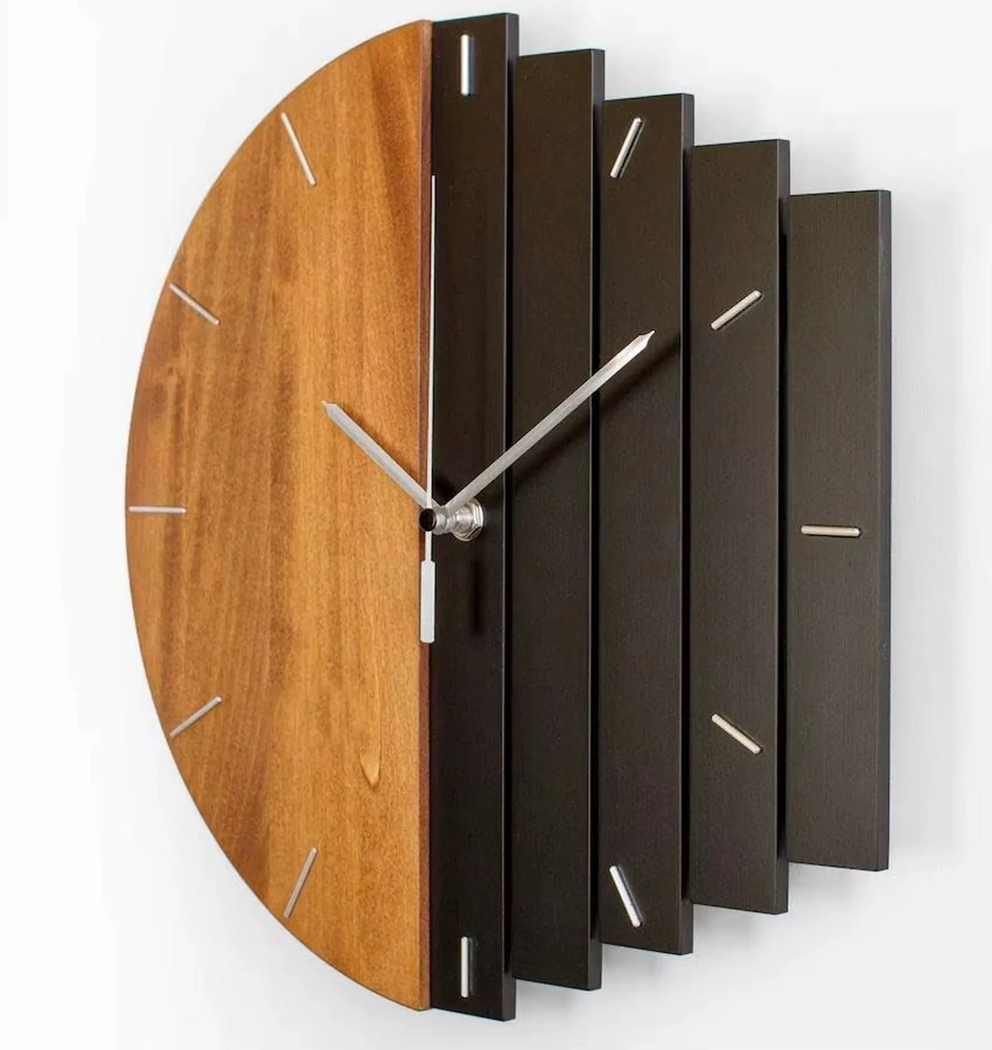 Modern wood wall clock - Clevor featuring a split face design with smooth wood and darker slats, slim metal markers, and sleek silver hands; ideal for large spaces or lofts.