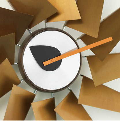 Decorative wall clock with brown and orange hand on a white background