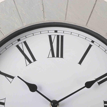 Large outdoor wall clock - Sylva featuring a white face with black Roman numerals and slender black hands, ideal for patios and gardens, mounted against a textured background, adding timeless elegance to any space.