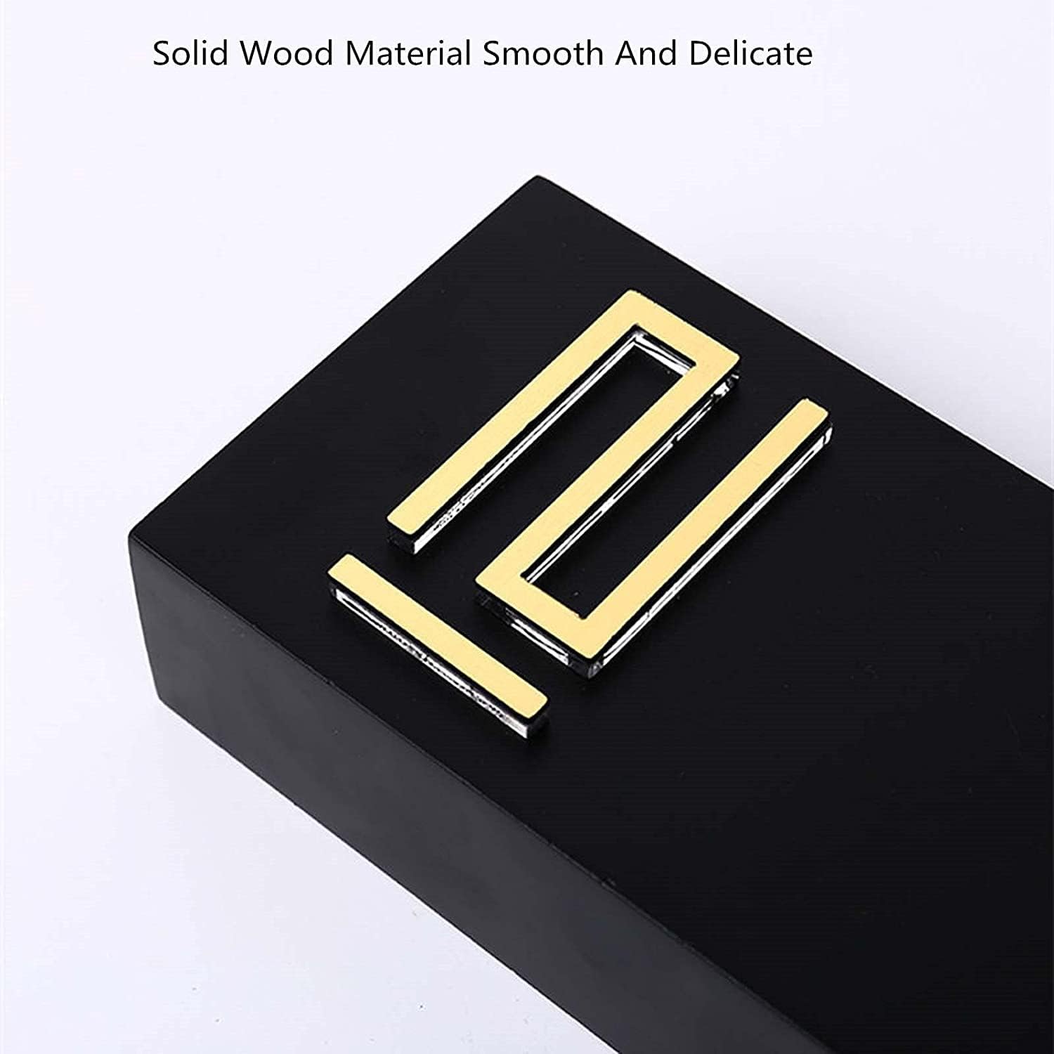 Set of four modern gold-finish handles displayed on black block; tagline reads Solid Wood Material Smooth And Delicate.