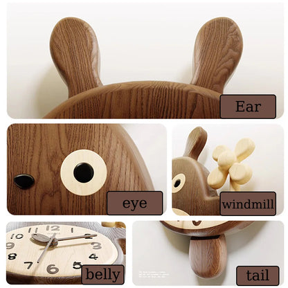 Veynor small decorative wall clock shaped like a bunny, featuring ear-topped design with a round clock face as its belly, eye detail, windmill propeller, and a rounded wooden tail.