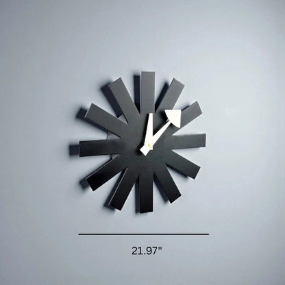 Modern black metal wall clock mounted above white console table in living room