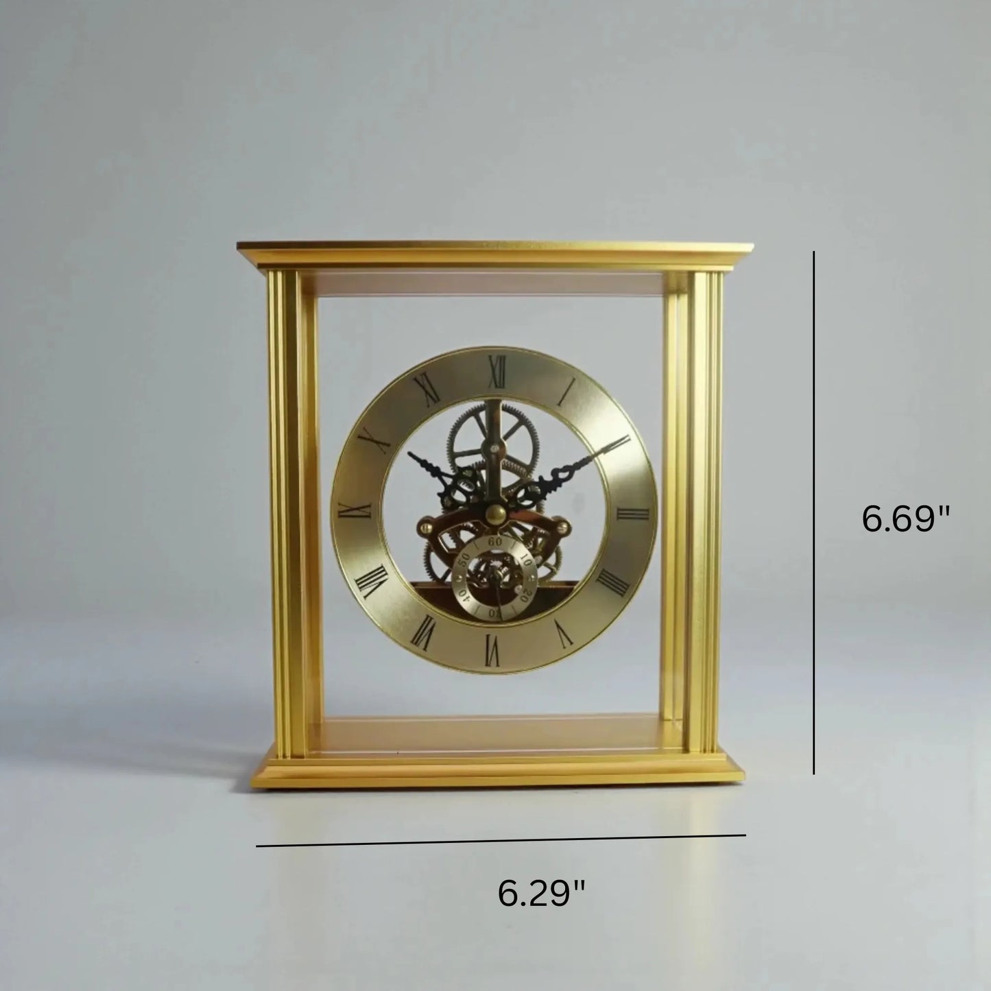 Brass table clock - Braven: A gold-tone skeleton clock in a clear case, showcasing visible gears and escapement. Features a simple dial with Roman numerals and a seconds sub-dial, measuring 6.29 wide by 6.69 tall.