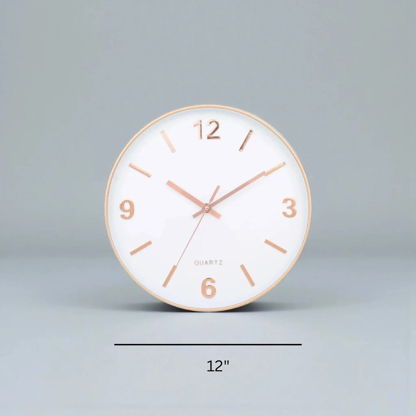 Modern Silent Wall Clock - Densford: A 12 round clock with a white face, rose-gold markers, and silent quartz movement, embodying minimalist elegance, ideal for a contemporary setting.
