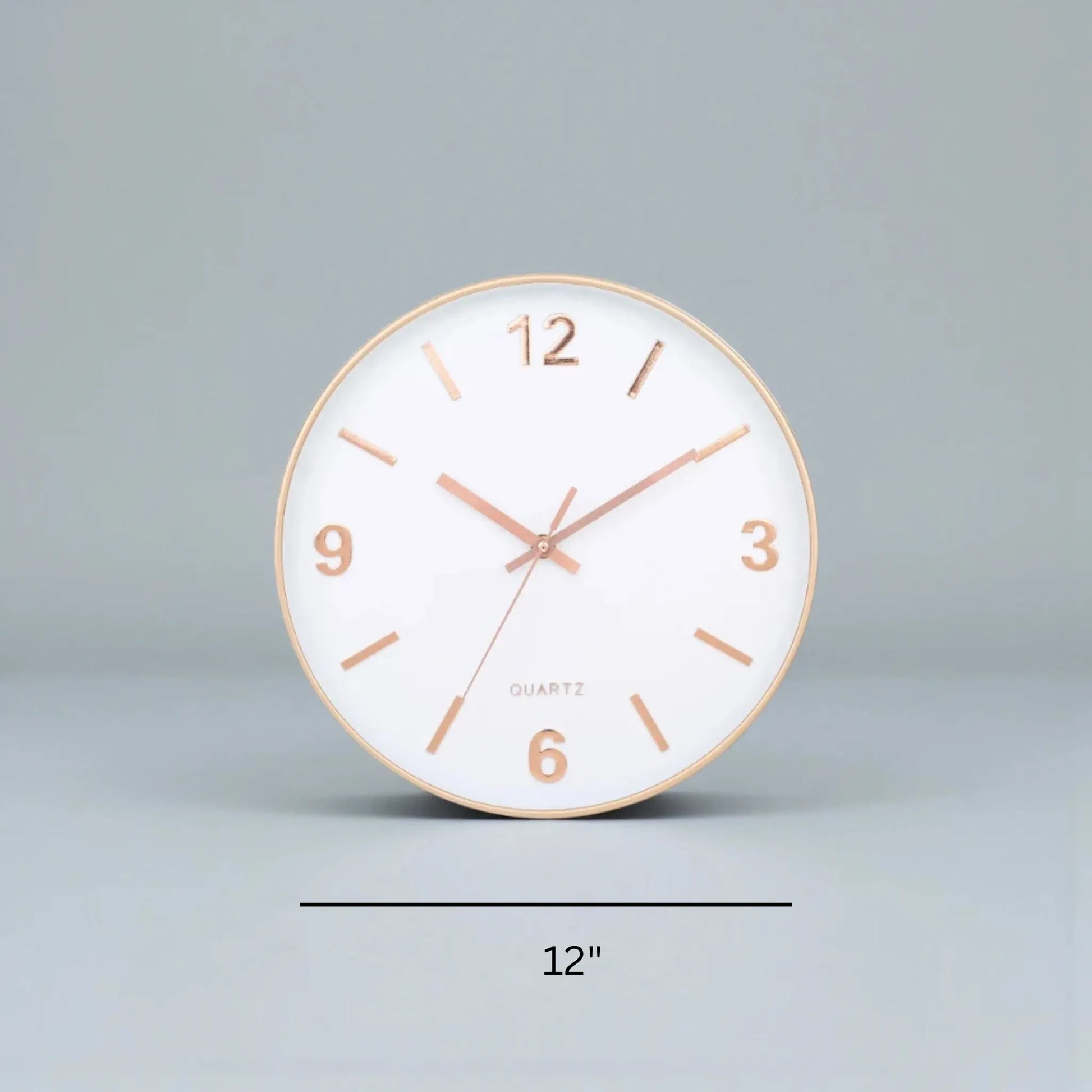 Modern Silent Wall Clock - Densford: A 12 round clock with a white face, rose-gold markers, and silent quartz movement, embodying minimalist elegance, ideal for a contemporary setting.