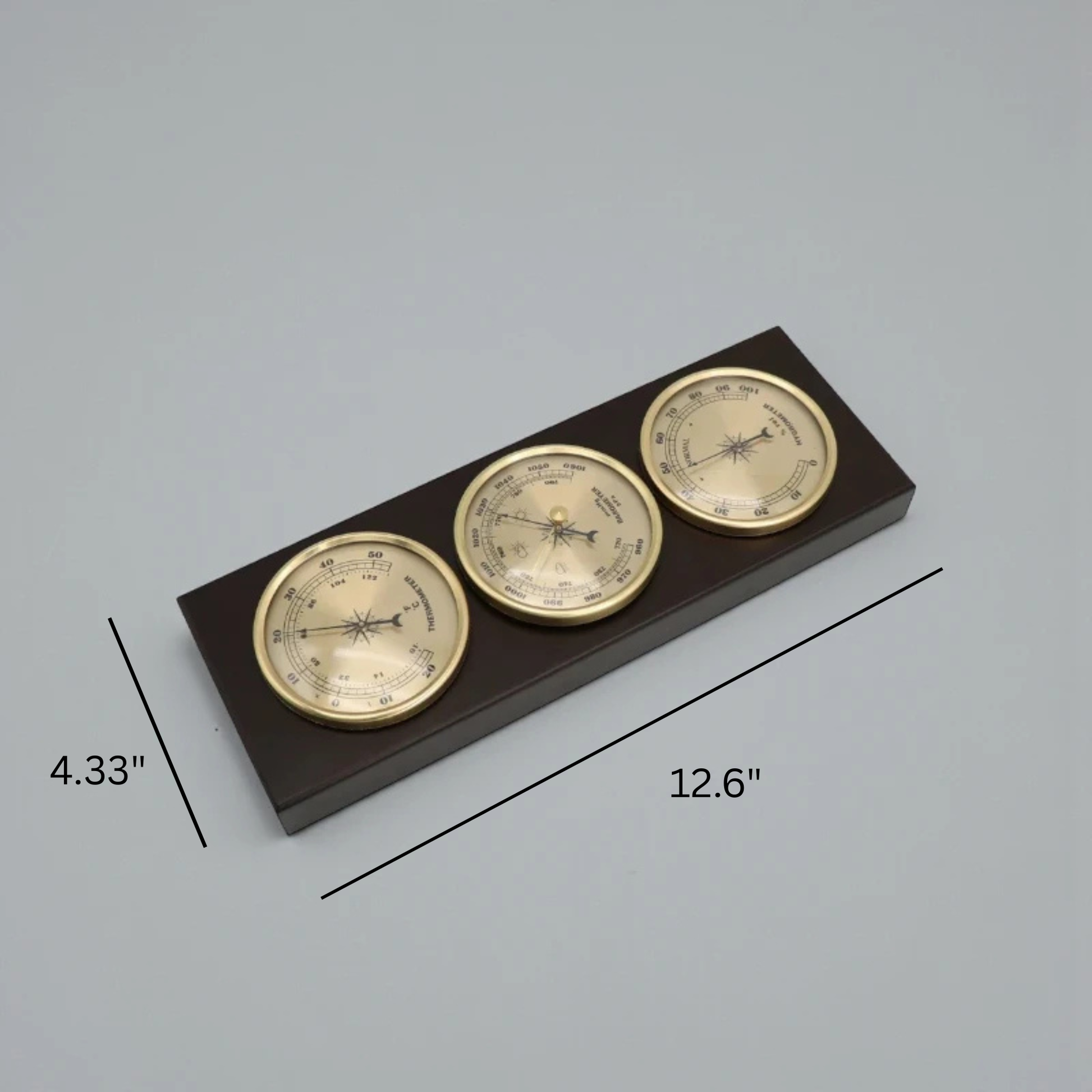 Weather Station Wall Clock - Harlton featuring three brass-colored gauges (thermometer, barometer, hygrometer) elegantly mounted in a dark wooden base, perfect for monitoring indoor conditions with sophistication.