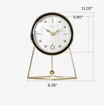 Pendulum Table Clock - Dralen features a round face with gold accents in a gold-tone frame and triangular base, enhanced by a swinging pendulum, ideal for elegant mantel or desk display.