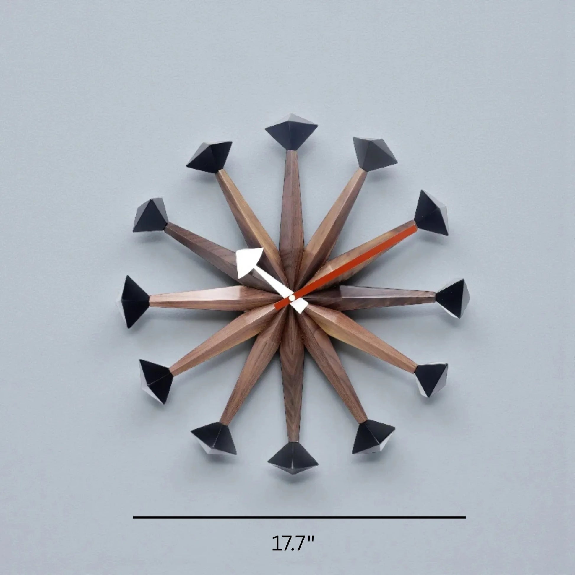 Decorative wall clocks modern - Drayen: A 17.7" clock with wooden rays and black geometric caps, featuring simple white and orange hands, embodying mid-century modern style.