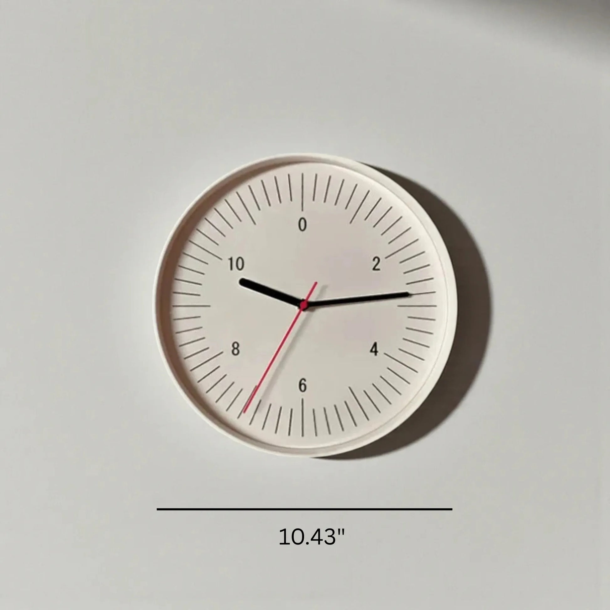 Numbers wall clock - Dunmore features a minimalist design with bold numerals, black hour and minute hands, and a slender red second hand on a white face, measuring 10.4 inches in diameter.