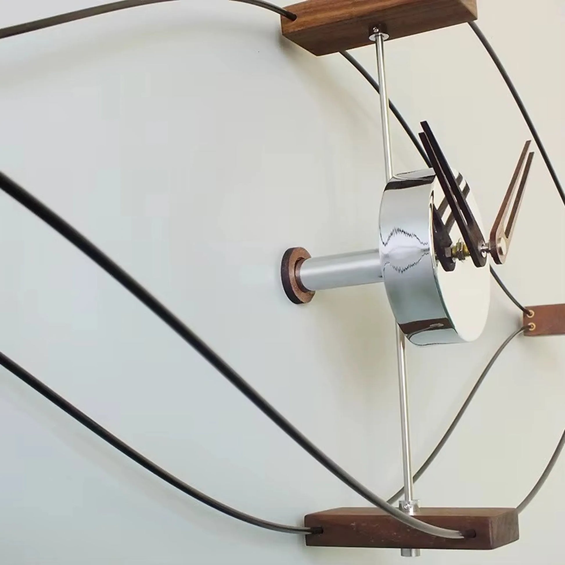 Metal wall clock with walnut wood center hub and numberless dial