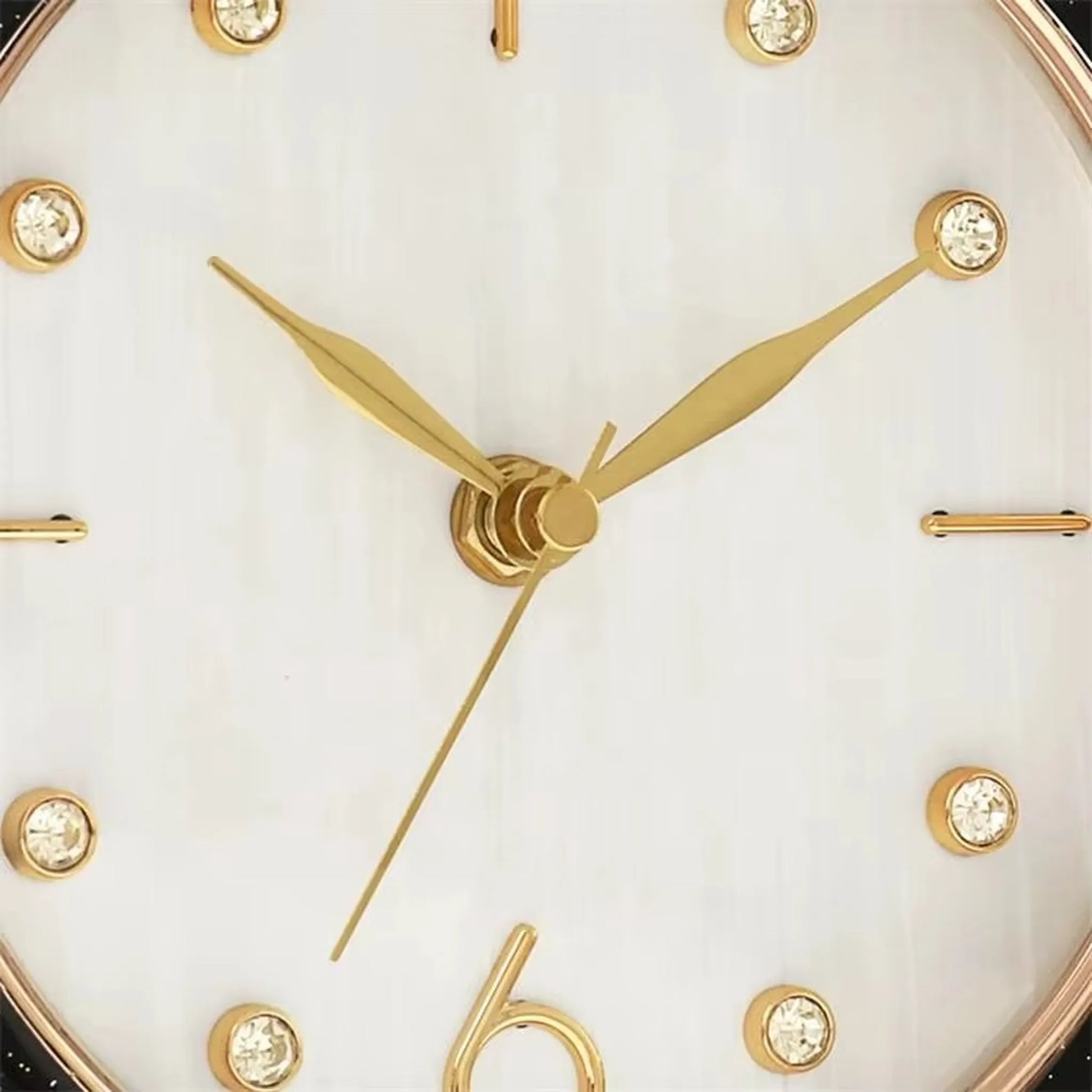 Pendulum Table Clock - Dralen: Close-up of an analog face with gold-tone hands and gem hour markers, set in a modern design with a swinging pendulum, perfect for mantel or desk.