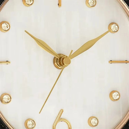 Pendulum Table Clock - Dralen: Close-up of an analog face with gold-tone hands and gem hour markers, set in a modern design with a swinging pendulum, perfect for mantel or desk.