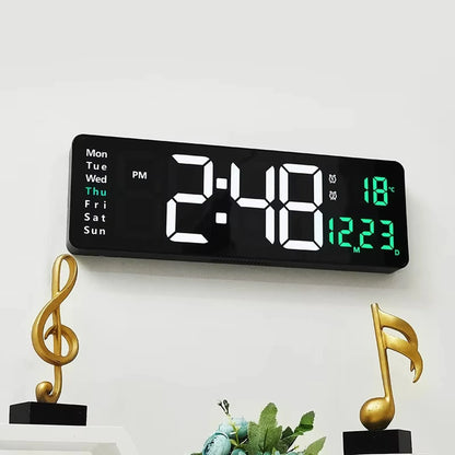 Large digital wall clock - Eldon with bold LED display showing 2:48 PM, Thu, temperature 18 °C, and date 12 23, mounted above a shelf with golden music-note sculptures.