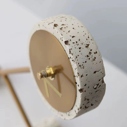 Metal Tabletop Clock - Winsley features a minimalist design with a thick travertine-like stone base and an exposed brass clock mechanism, showcasing its industrial charm and decorative gears.