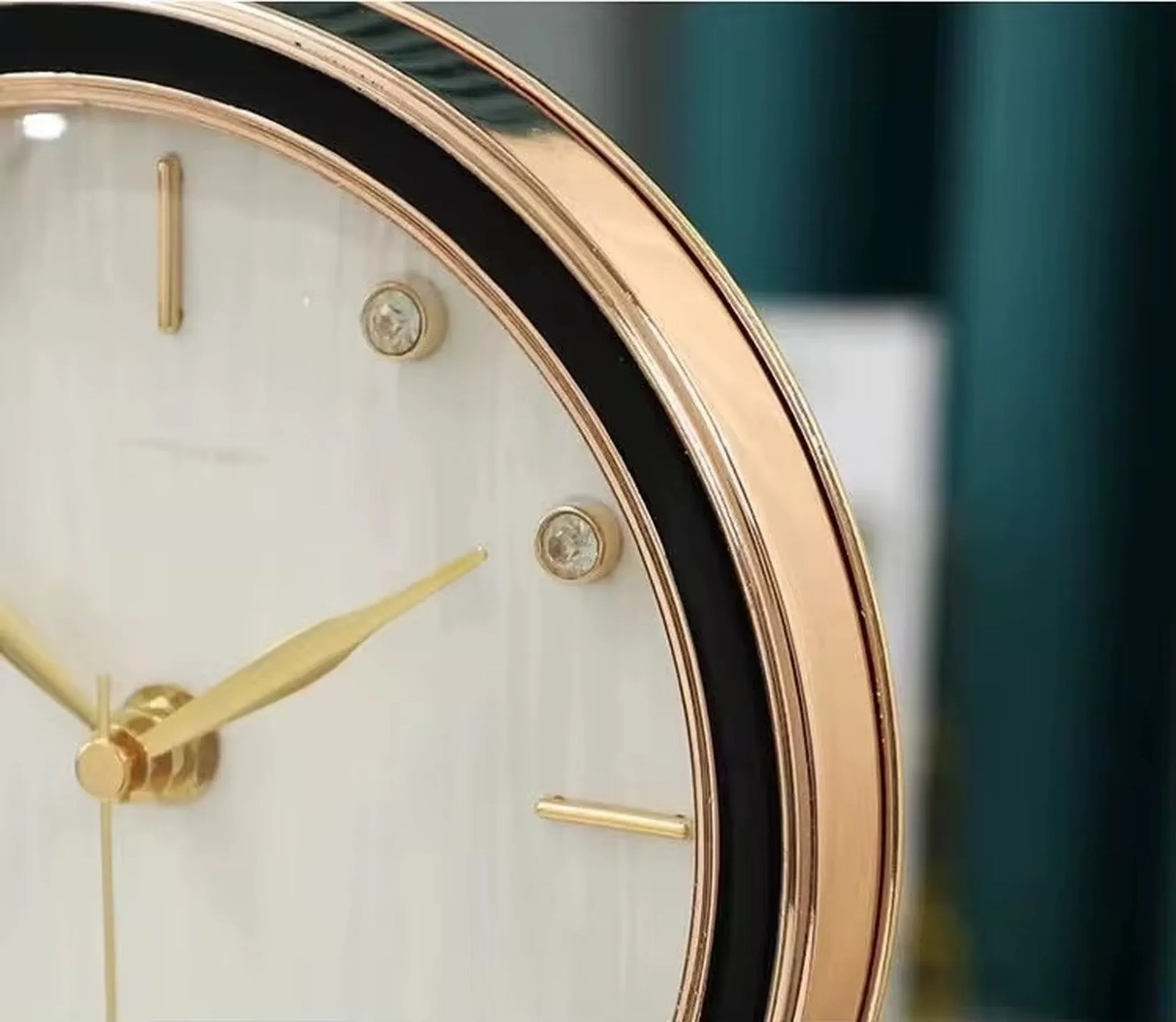 Dralen Pendulum Table Clock features a gold-tone bezel, white dial with gold hands, hour markers, and crystal-like studs, highlighting its modern elegance and unique pendulum design.