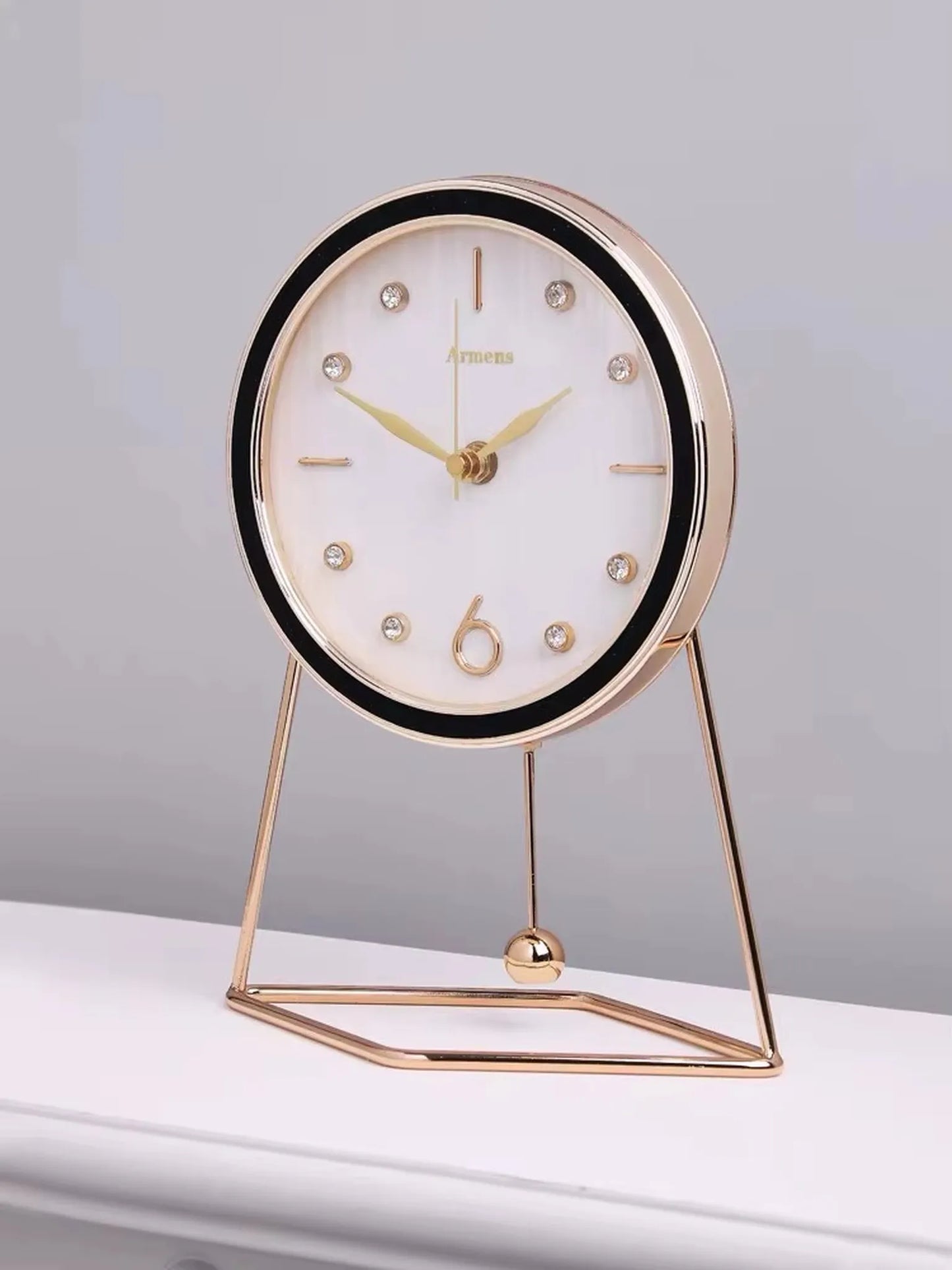 Pendulum Table Clock - Dralen: A modern, elegant tabletop clock with a round face, minimalist gold markers, and a swinging pendulum, perfect for enhancing your mantel or desk with dynamic elegance.