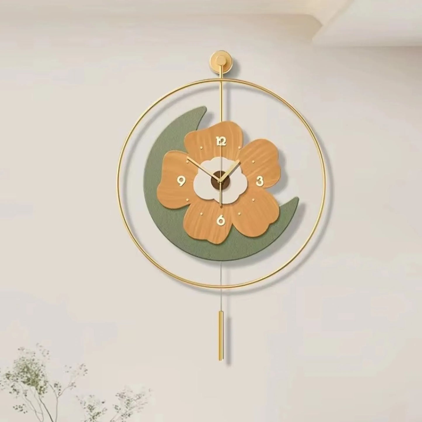 Flower wall clock - Fenton: A stylish clock featuring a flower design with light-wood petals, numbers, and a green crescent, encased in a gold hoop with a matching pendulum, ideal for modern decor.