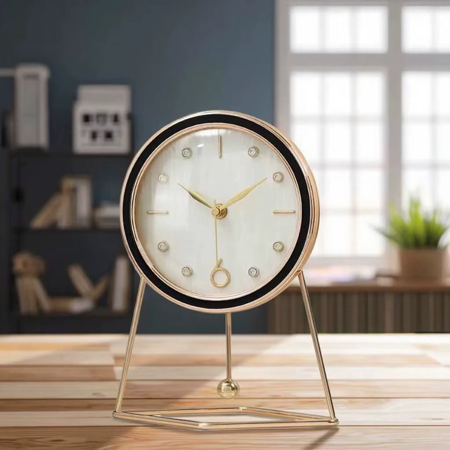 Dralen Pendulum Table Clock: A minimalist round clock with gold-tone hands and geometric gold stand, featuring a rhythmic pendulum, perfect for adding elegance to any mantel or desk.