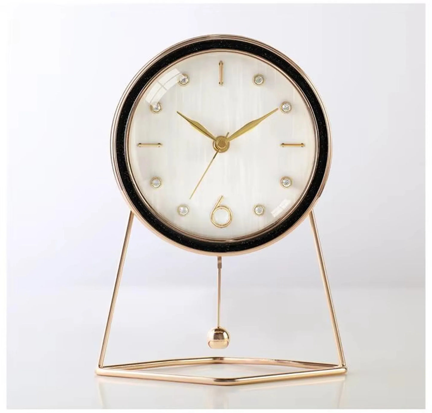 Pendulum Table Clock - Dralen: A modern timepiece with a round white face and gold-tone hands, housed in a slim gold case on a triangular frame, featuring a decorative swinging pendulum.