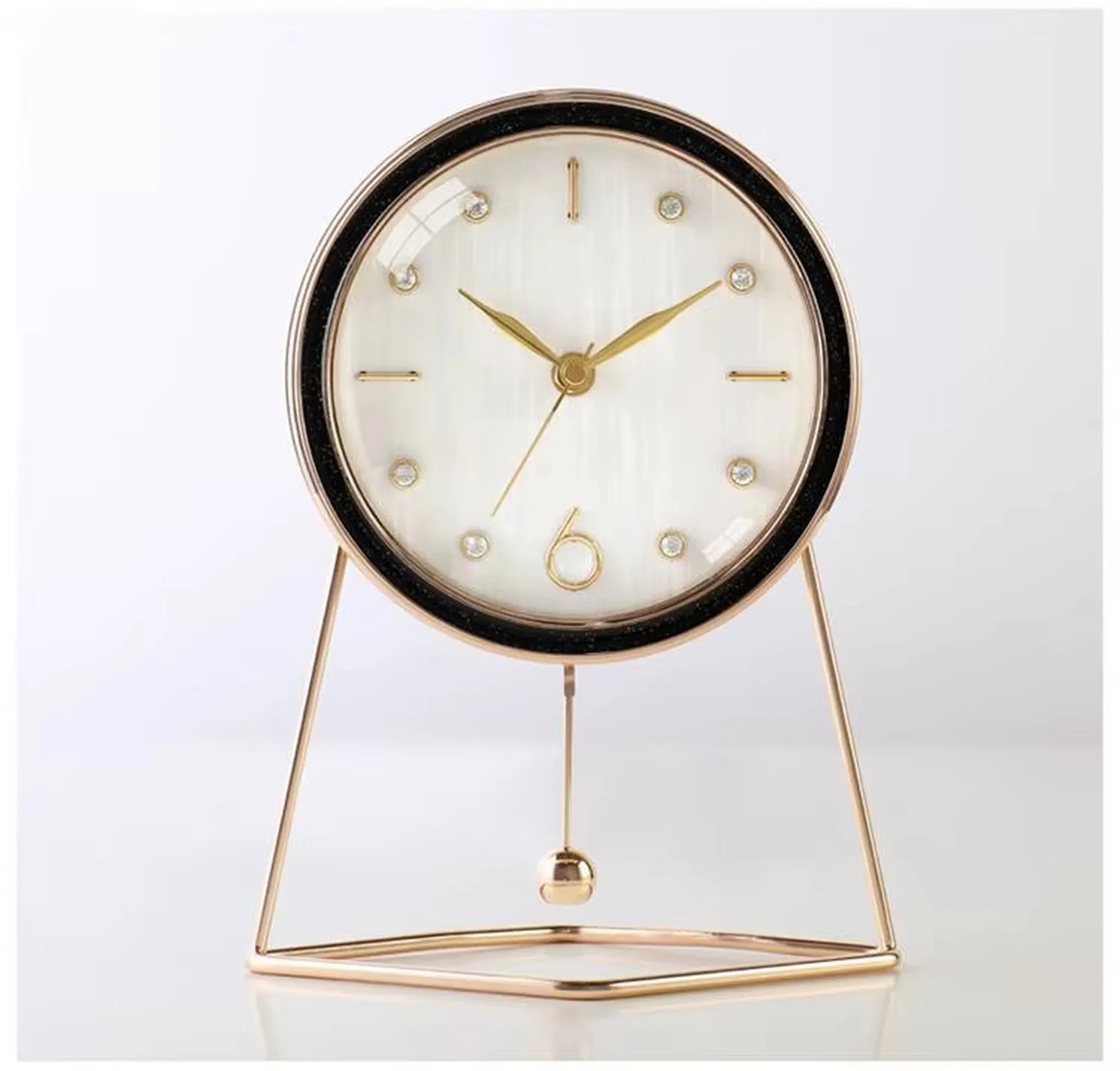 Pendulum Table Clock - Dralen: A modern timepiece with a round white face and gold-tone hands, housed in a slim gold case on a triangular frame, featuring a decorative swinging pendulum.