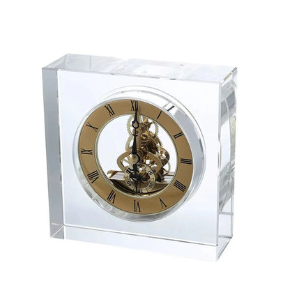 Crystal tabletop clock - Dunley, featuring a transparent, beveled glass design with exposed brass-colored gears and Roman numerals, showcasing modern elegance perfect for desks or mantels.