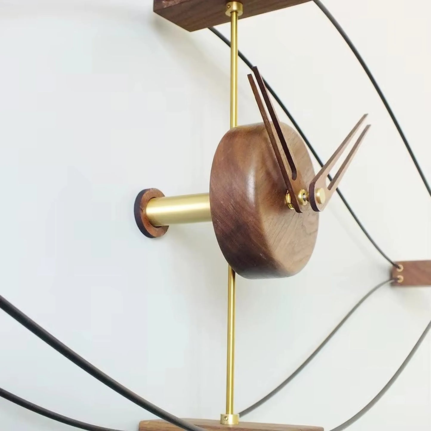 Sculptural clock and wall decor vignette with plants and ceramic vases