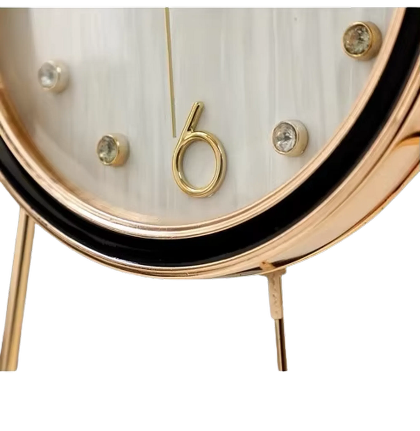 Pendulum Table Clock - Dralen: A close-up of this elegant clock features a gold-tone bezel and legs, white face with crystal markers, and a stylized gold “6” at the bottom.