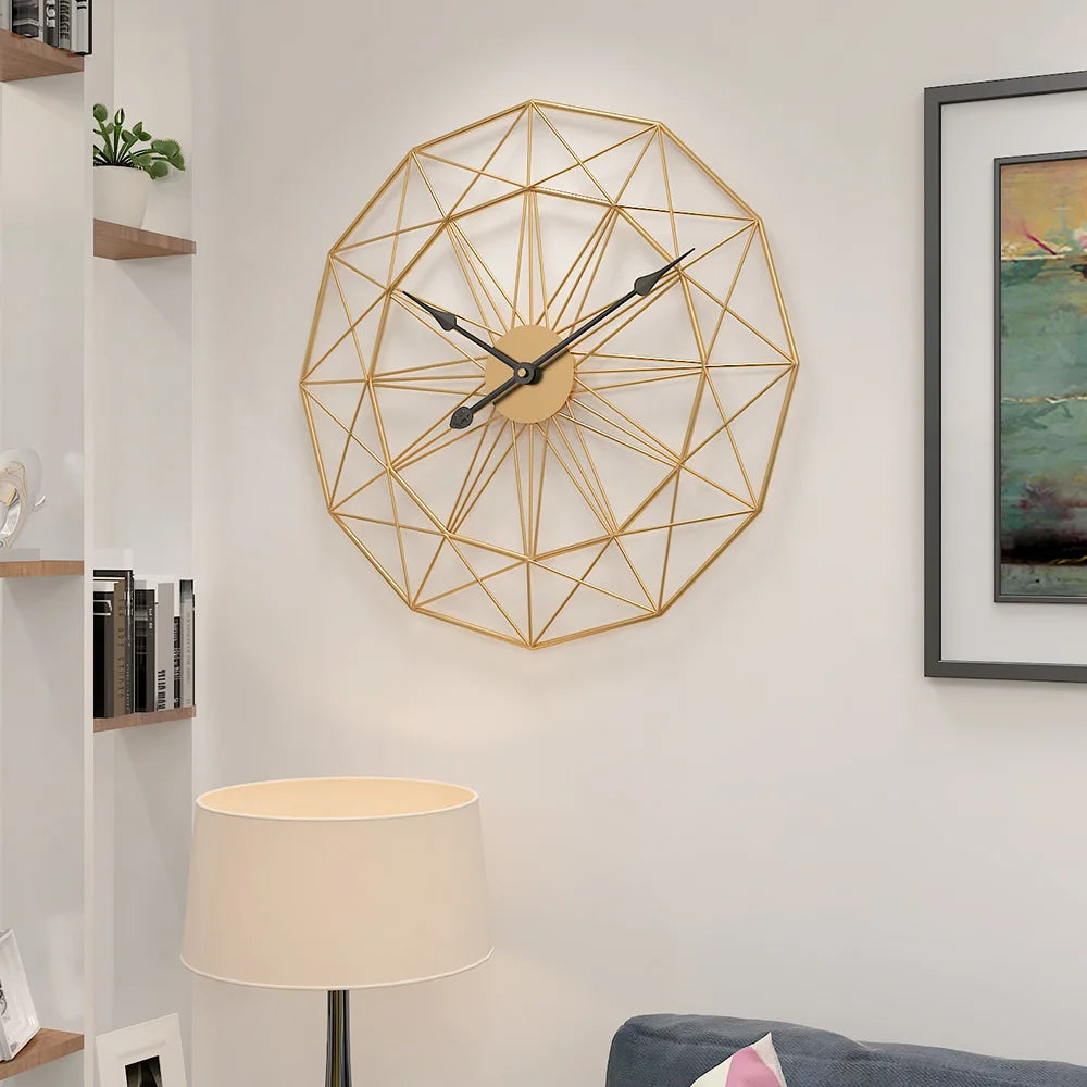Modern Style Wall Clock - Blenford: A gold-finish wireframe clock with black hands, featuring interlocking geometric shapes, adds minimalist elegance to a living-room corner, complementing shelves, a lamp, and artwork.