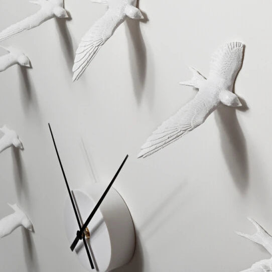Decorative kitchen wall clocks - Darven features a flock of sculpted birds forming the clock face, with slim black hands indicating time, perfect for enhancing open kitchen spaces with artistic flair.