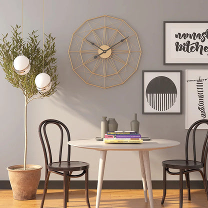 Modern Style Wall Clock - Blenford: A geometric open-frame clock with gold metal spokes above a dining nook, complementing minimalist decor with pendant lights and framed art.