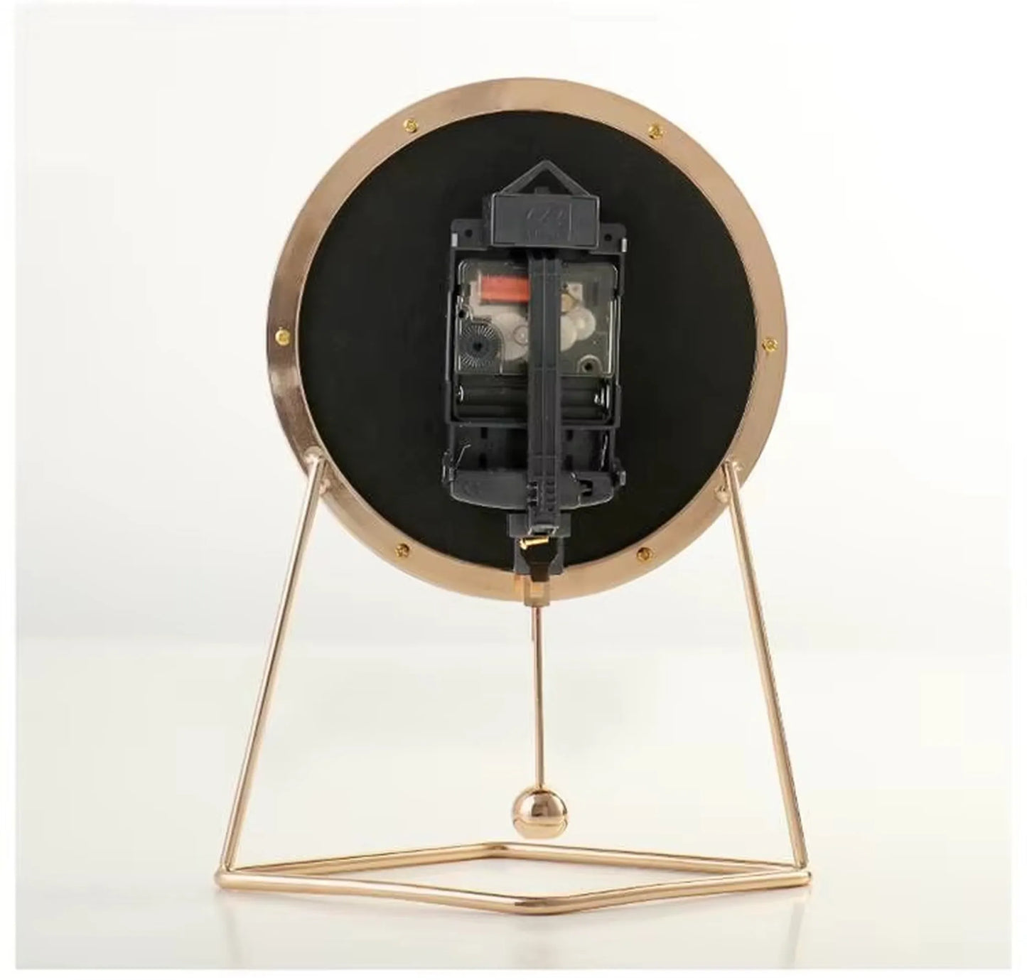 Pendulum Table Clock - Dralen: A minimalist tabletop clock showcasing the back view, featuring a quartz movement, visible gears, AA batteries, and a rhythmic swinging pendulum within a gold metal stand.