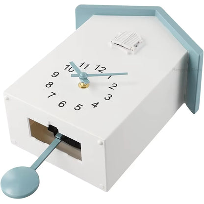 Wooden Cuckoo Clock - Brivon: A house-shaped wall clock with a circular face on the sloped roof, featuring a tiny shuttered cuckoo door and a swinging bird pendulum, adding modern charm to any room.
