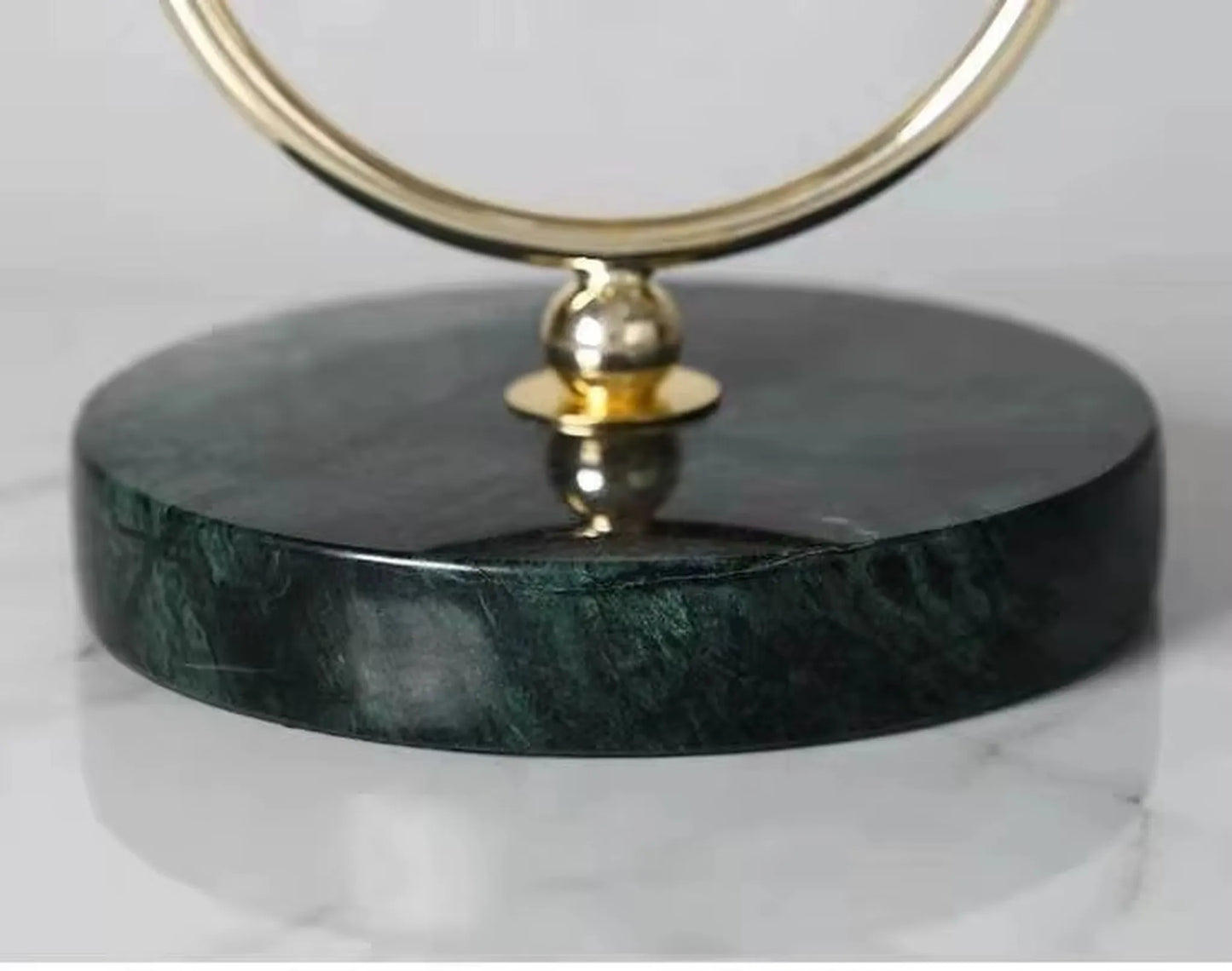 Pendulum Table Clock - Leiton with a polished brass ring atop a dark marble base, designed for elegant mantel or desk display, showcasing unique, open-concept timekeeping from The Horologista.