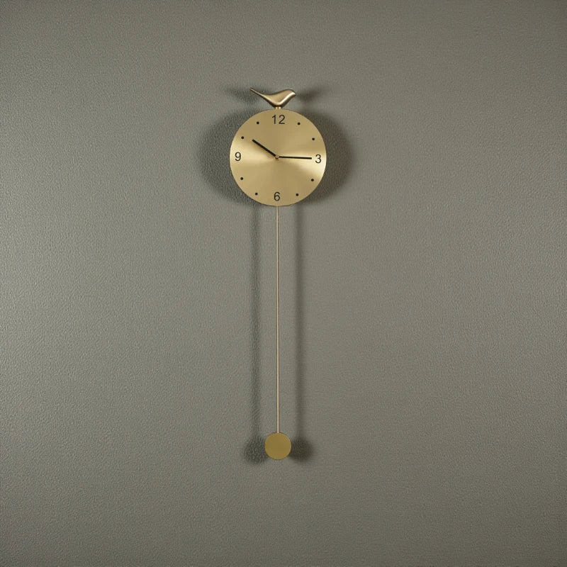 Modern pendulum wall clock - Majesty: A sleek brass-faced clock with minimalist markers, a slender pendulum, and a small bird atop, designed to enhance contemporary decor with its unique, sophisticated presence.
