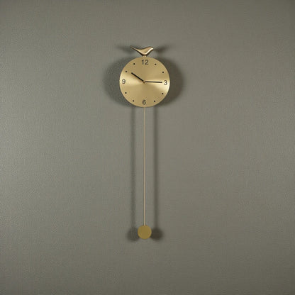 Modern pendulum wall clock - Majesty: A sleek brass-faced clock with minimalist markers, a slender pendulum, and a small bird atop, designed to enhance contemporary decor with its unique, sophisticated presence.