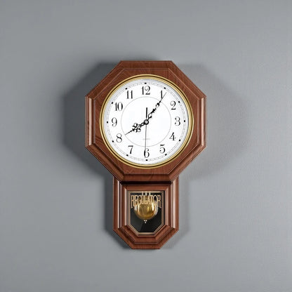 Vintage wall clock pendulum - Heritage: A classic regulator-style clock with an octagonal wooden case, white face with black hands and numerals, and a brass pendulum visible through a glass compartment.