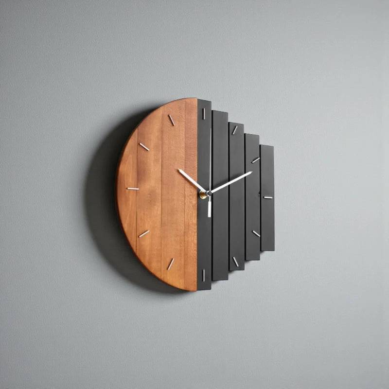 Modern wood wall clock - Clevor, featuring a half wood, half staggered black slat design with brass accents and white hands; perfect for large spaces, crafted from European linden wood.