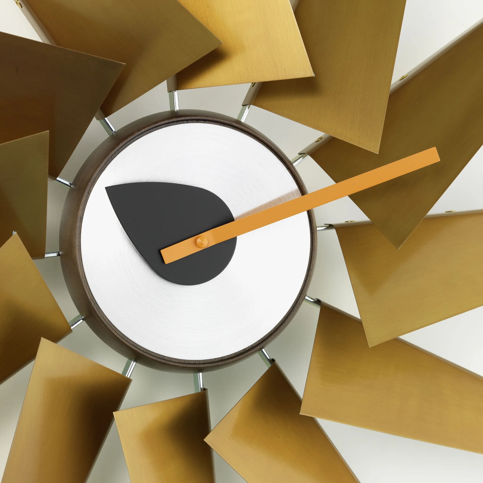 Modern clock with gold design on a white background
