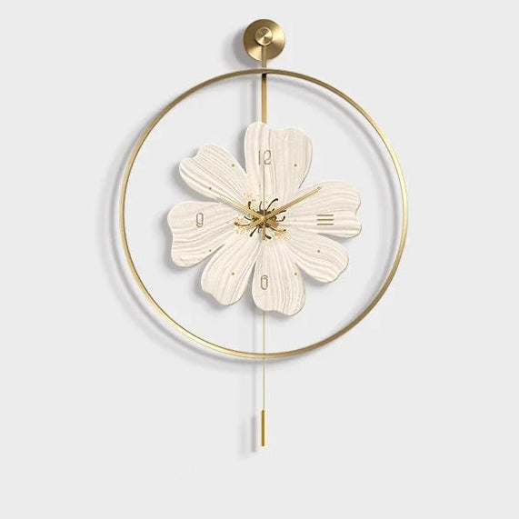 Flower wall clock - Fentin: A decorative wall clock styled as a six-petaled flower with gold hour markers and hands, encased in a circular gold frame with a hanging pendulum rod.