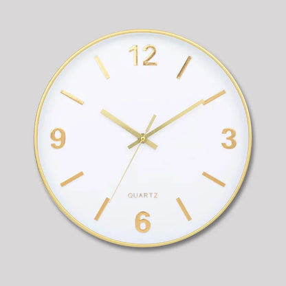 Modern Silent Wall Clock - Densford: A sleek round analog clock with a white face, gold accents, and silent quartz movement. Features minimalist gold hour markers and hands, set to 10:10.