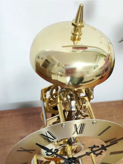 Glass dome clock - Stanley featuring exposed brass skeleton movement, Roman-numeral chapter ring, and hourly strike bell, capturing vintage charm with its open-frame design, perfect for mantel display.