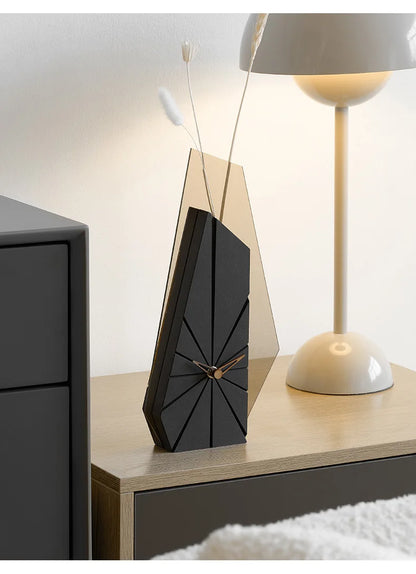 Black clock face with etched radiating lines and rose gold hands detail
