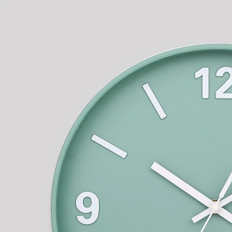 Modern Silent Wall Clock - Densford, featuring a mint-green face with white hour markers and silent movement, exemplifies minimalist elegance, ideal for enhancing contemporary spaces with quiet sophistication.