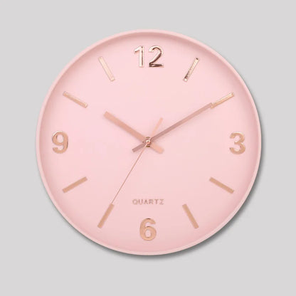 Modern Silent Wall Clock - Densford featuring a pastel-pink face with rose-gold hour markers and hands, offering a minimalist design with a silent quartz movement, perfect for contemporary decor.
