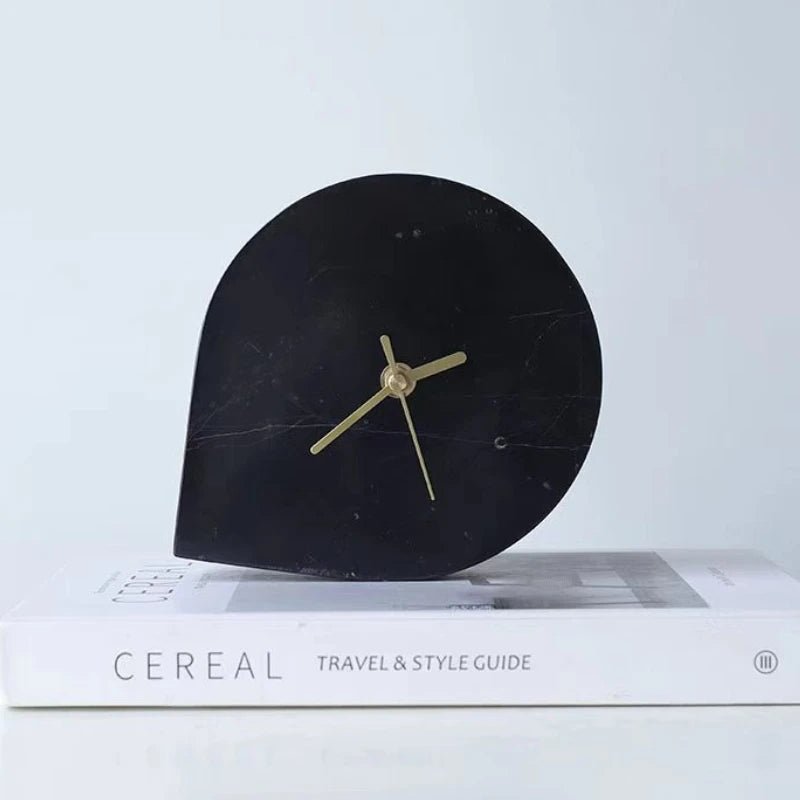 Side view showing marble clock's sculptural arch profile