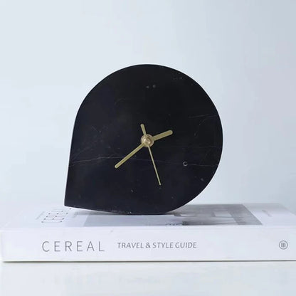 Side view showing marble clock's sculptural arch profile