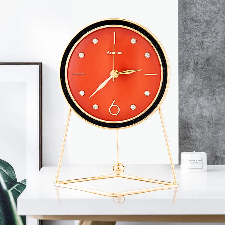 Pendulum Table Clock - Dralen: A modern tabletop clock with a deep-red face and gold accents on a minimalist gold stand, showcasing artistic motion with an open-concept design and rhythmic pendulum.